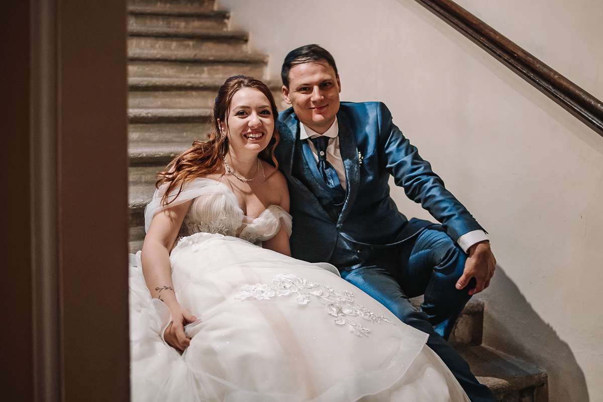 Matrimonio al Castello Canalis di Cumiana(TO). Cena. sposi seduti sulle scale che aspettano di entrare