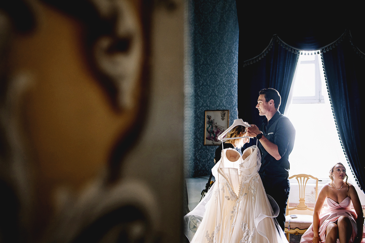 Matrimonio al Castello Canalis di Cumiana(TO). Videomaker alto che trasporta l'abito della sposa