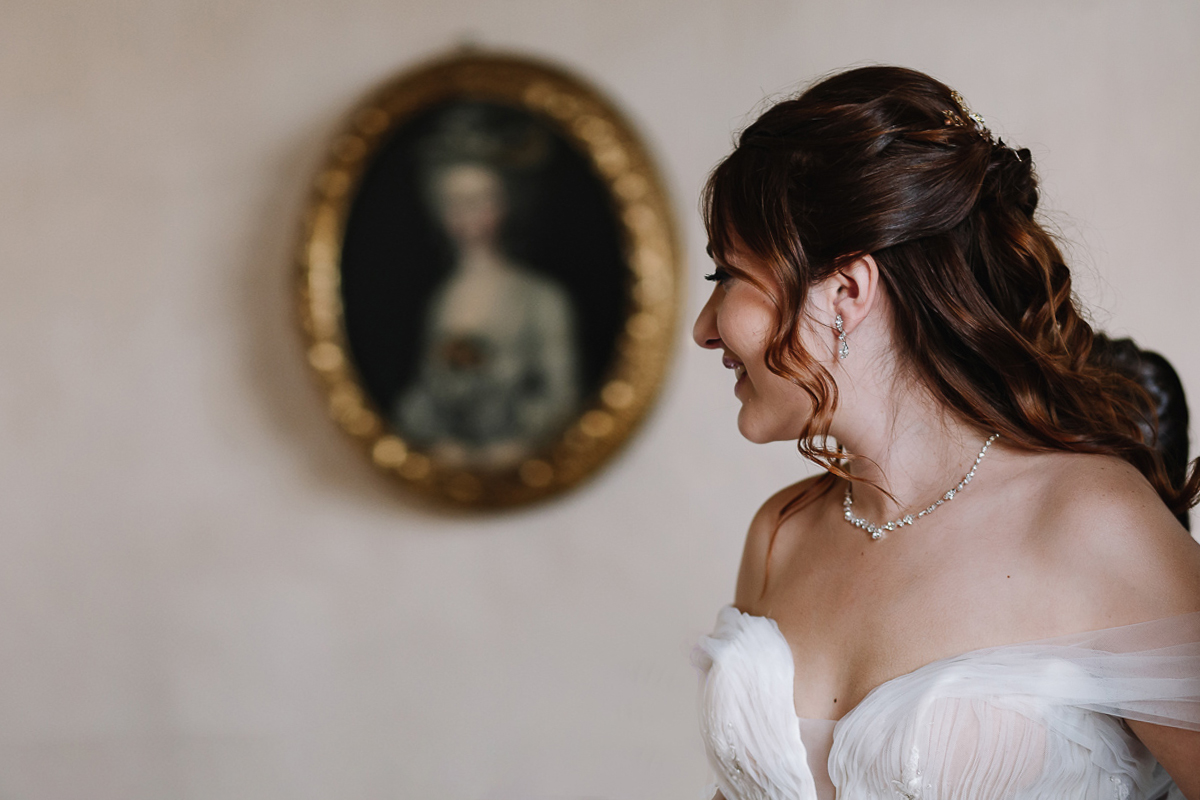 Matrimonio al Castello Canalis di Cumiana(TO). Sposa davanti al quadro ovale di una dama del settecento