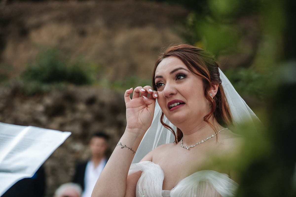 Matrimonio al Castello Canalis di Cumiana(TO). Cerimonia. Sposa commossa che si sciuga una lacrima