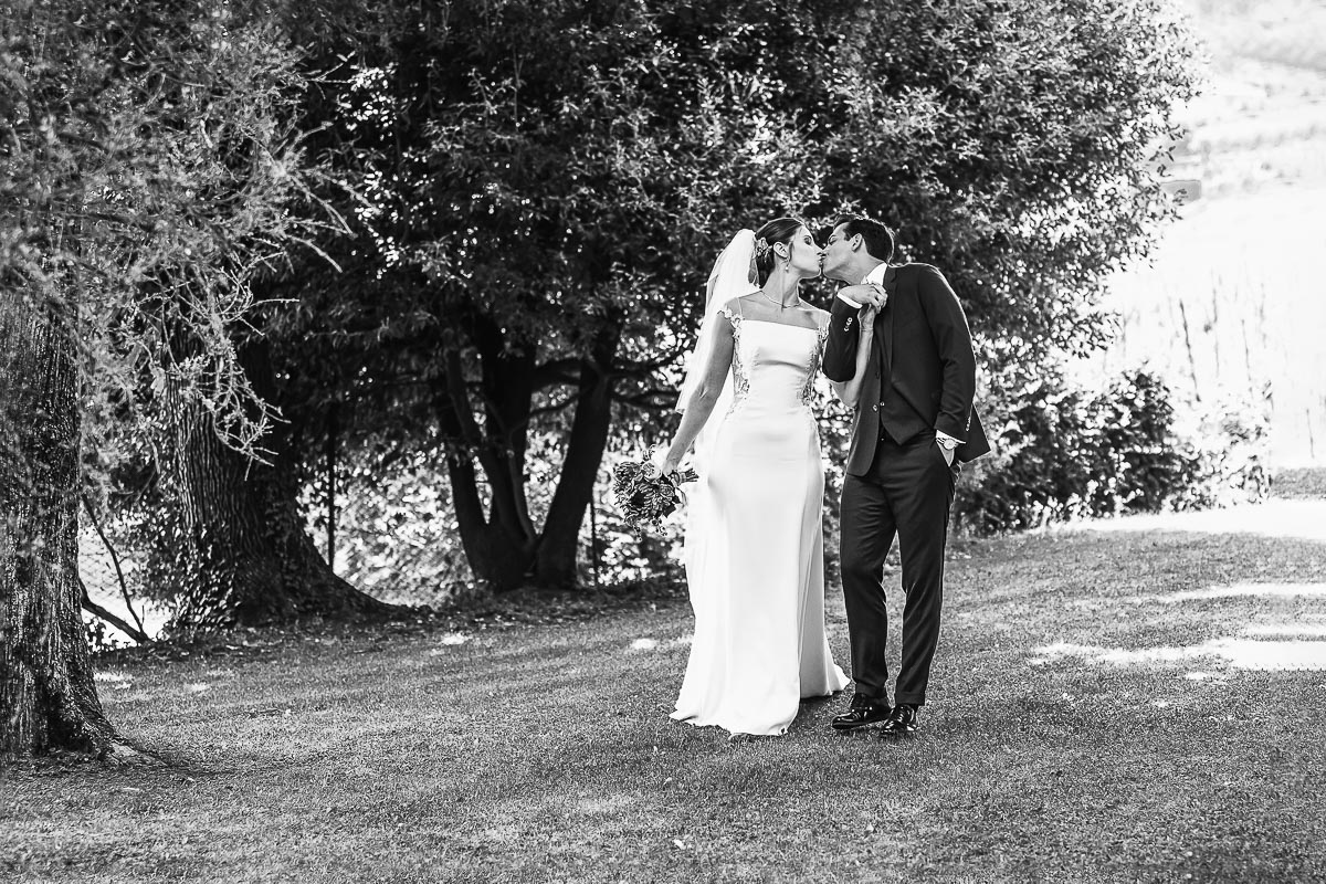 Castello Rosso di Costigliole di Saluzzo. Destination wedding. Sessione di coppia. sposi camminano baciandosi.