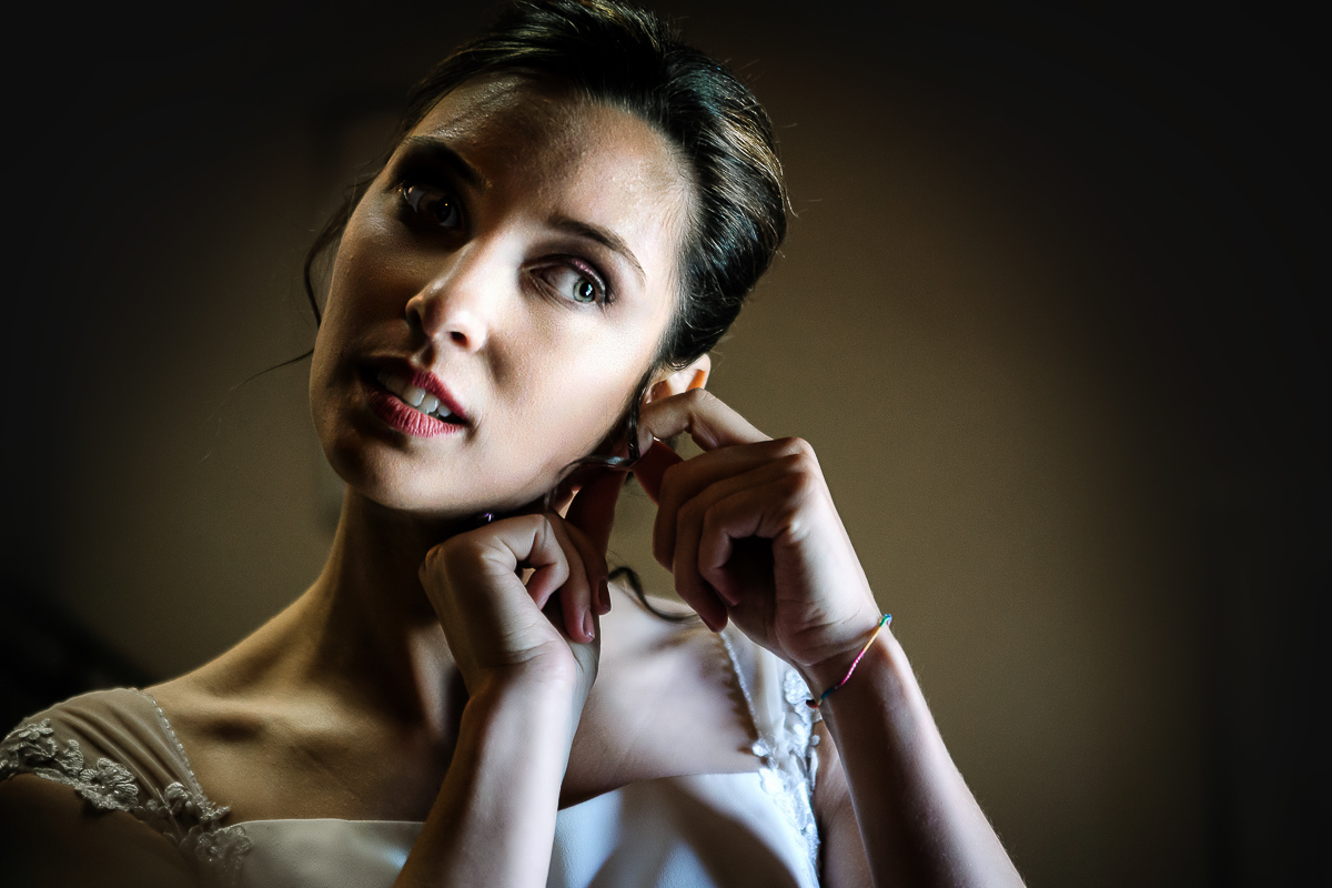Castello Rosso di Costigliole di Saluzzo. Destination wedding. Sposa si mette gli orecchini