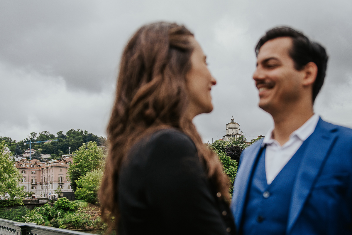 Engagement a Torino, in piazza Vittorio Veneto a Torino di Sara e Gabriel. Coppia sotto i portici. la coppia si guarda. tra di loro il Monte dei Cappuccini.
