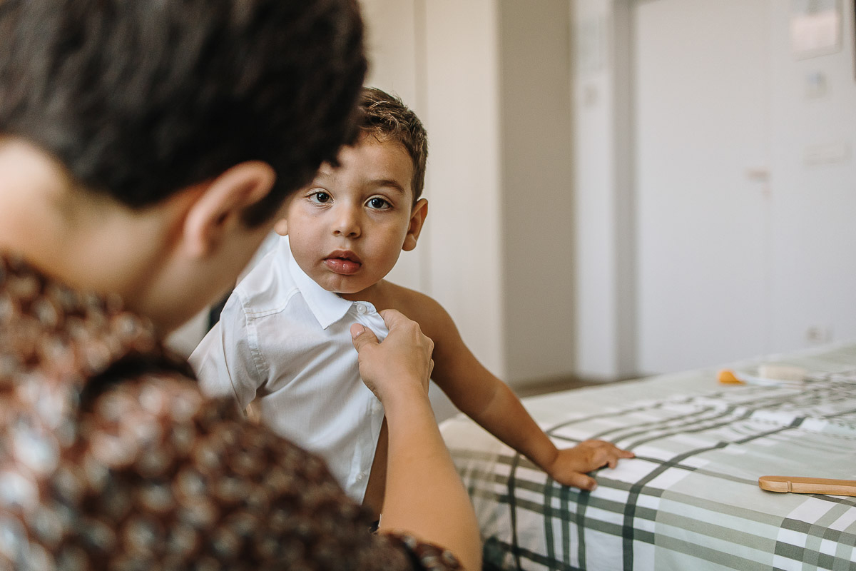 Casa Format, matrimonio italo-marocchino. Preparazione degli sposi. Baby sitter veste il figlio degli sposi.