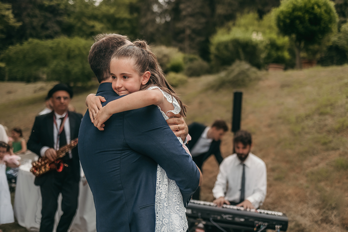 Villa Sassi matrimonio di Giulia e Nicolò. Aperitivo.Sposo prende in braccio la sua bambina.