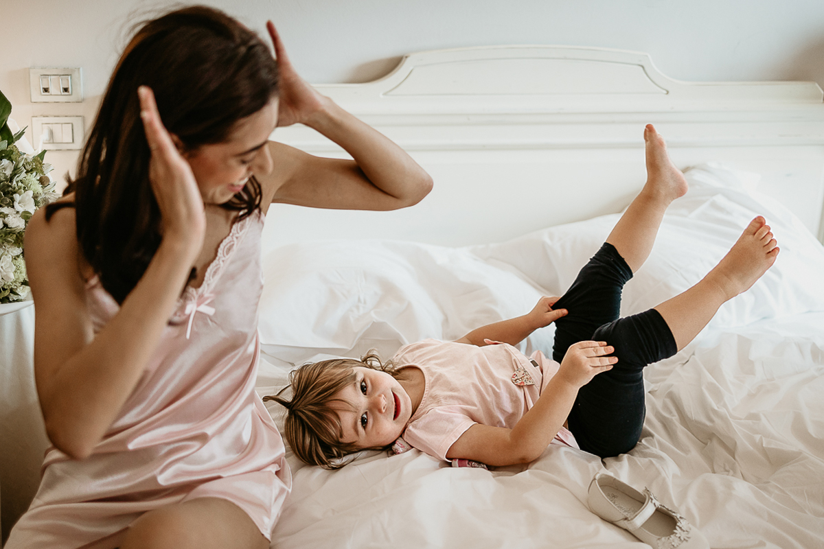 Tenuta La Cascinetta di Buriasco. Matrimonio. Preparazione della sposa. Sposa con la sua bambina sul letto