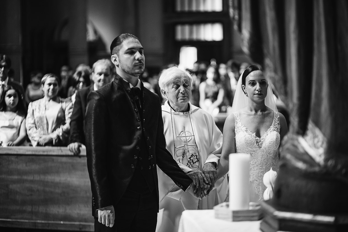 Matrimonio a Torino, chiesa di San Gioacchino. Cerimonia. Sposi con il sacerdote davanti alla statua della madonna.