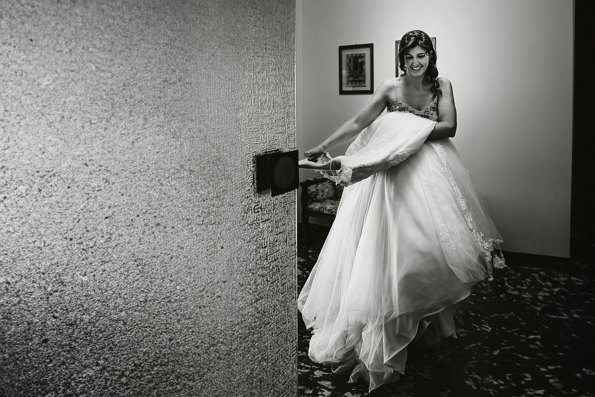 Matrimonio a Torino, preparazione della sposa.Sposa porta l'abito nel luogo della vestizione.