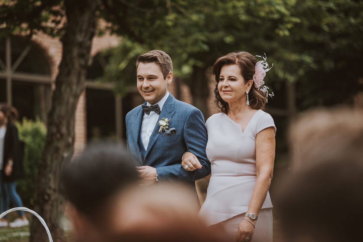 Destination wedding al Relais Sant'Uffizio. Cerimonia.Entrata dello sposo con la mamma..