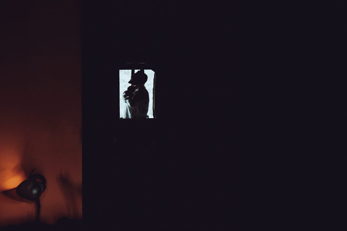 Matrimonio a Riva presso Chieri, preparazione dello sposo. Silhouette dello sposo che si veste riflesso in uno specchio