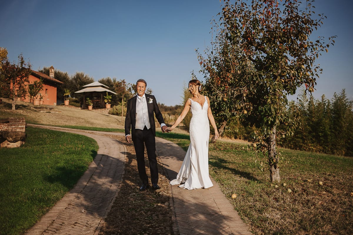 Post wedding a La Madernassa. Sposi passeggiano tra i peri che danno il nome alla location