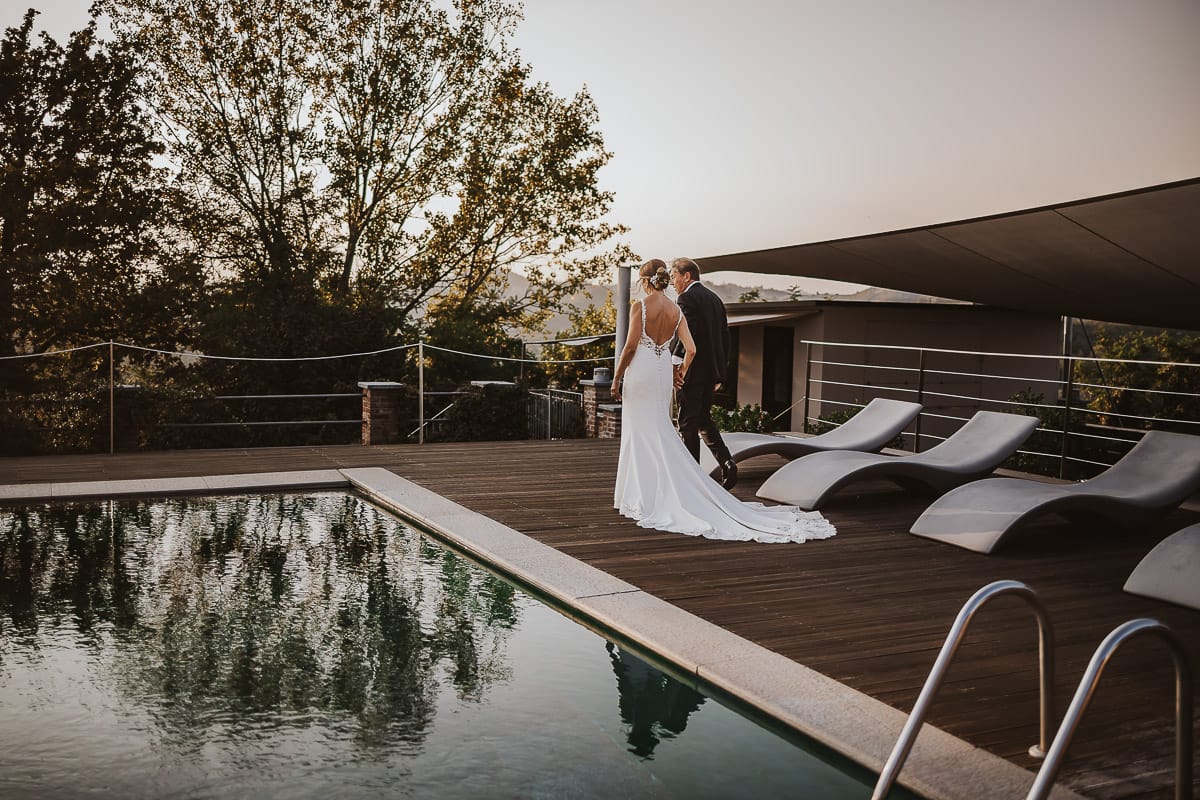 Post wedding a La Madernassa. Sposi passeggiano a bordo piscina