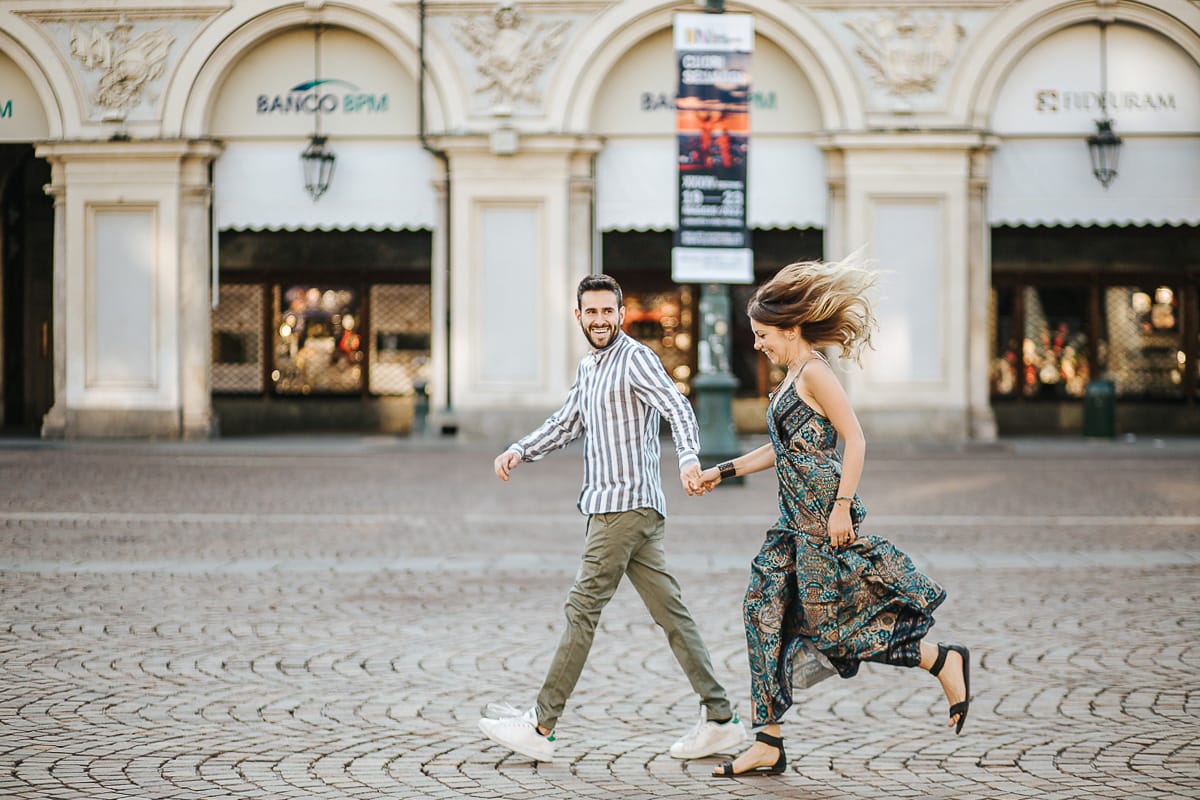 Prewedding nel centro di Torino Elisa e Davide in piazza San Carlo corrono