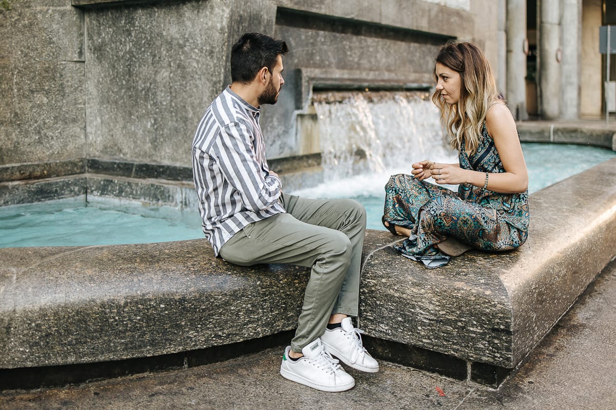 Prewedding nel centro di Torino Elisa e Davide in piazza San Carlo seduti sulla fontana di piazza CLN