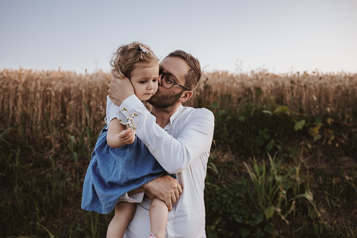 Un ritratto di famiglia al tramonto:Filippo tiene in braccio la piccola Camilla.