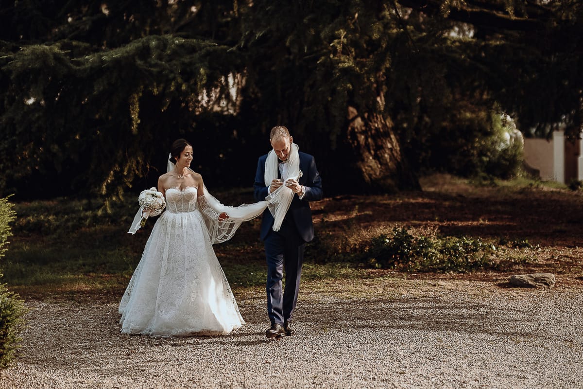 Matrimonio da favola al castello Canalis. Sposi lasciano il luogo dell'aperitivo per il loro servizio fotografico di coppia.