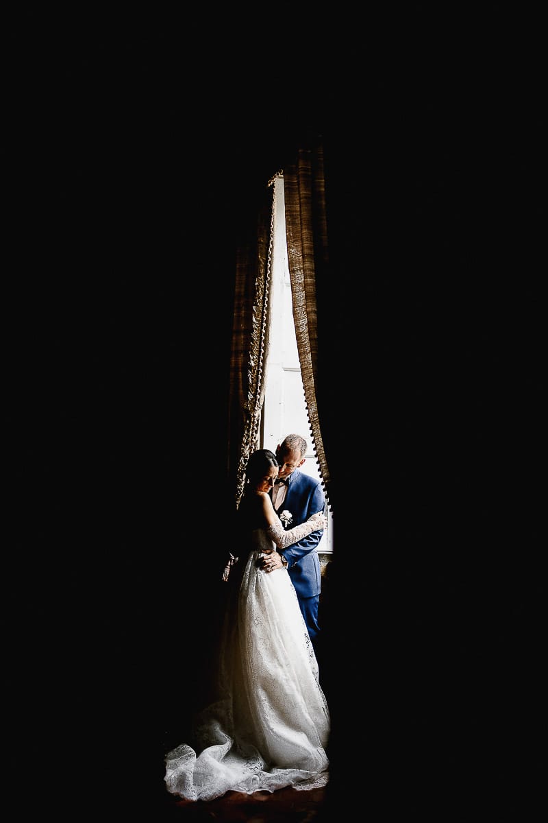Matrimonio da favola al castello Canalis. Ritratto degli sposi nelle sale del castello.Sposi davanti alla porta finestra