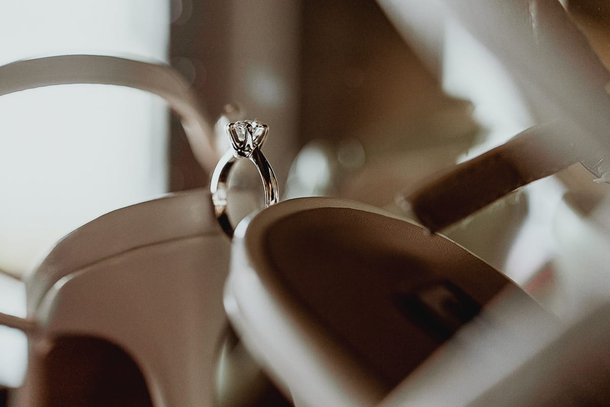 Matrimonio da favola al castello Canalis. Preparazione della sposa.Dettaglio dell'anello tra le scarpe