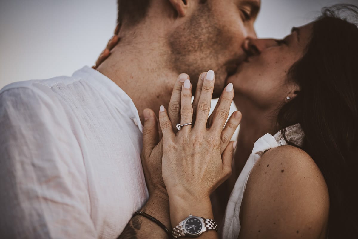Prewedding romantico e da sogno al tramonto in Monferrato. Ritratto intenso e ravvicinato di Valeria e Omar. Dettaglio sulla mano di Valeria con l'anello di fidanzamento..