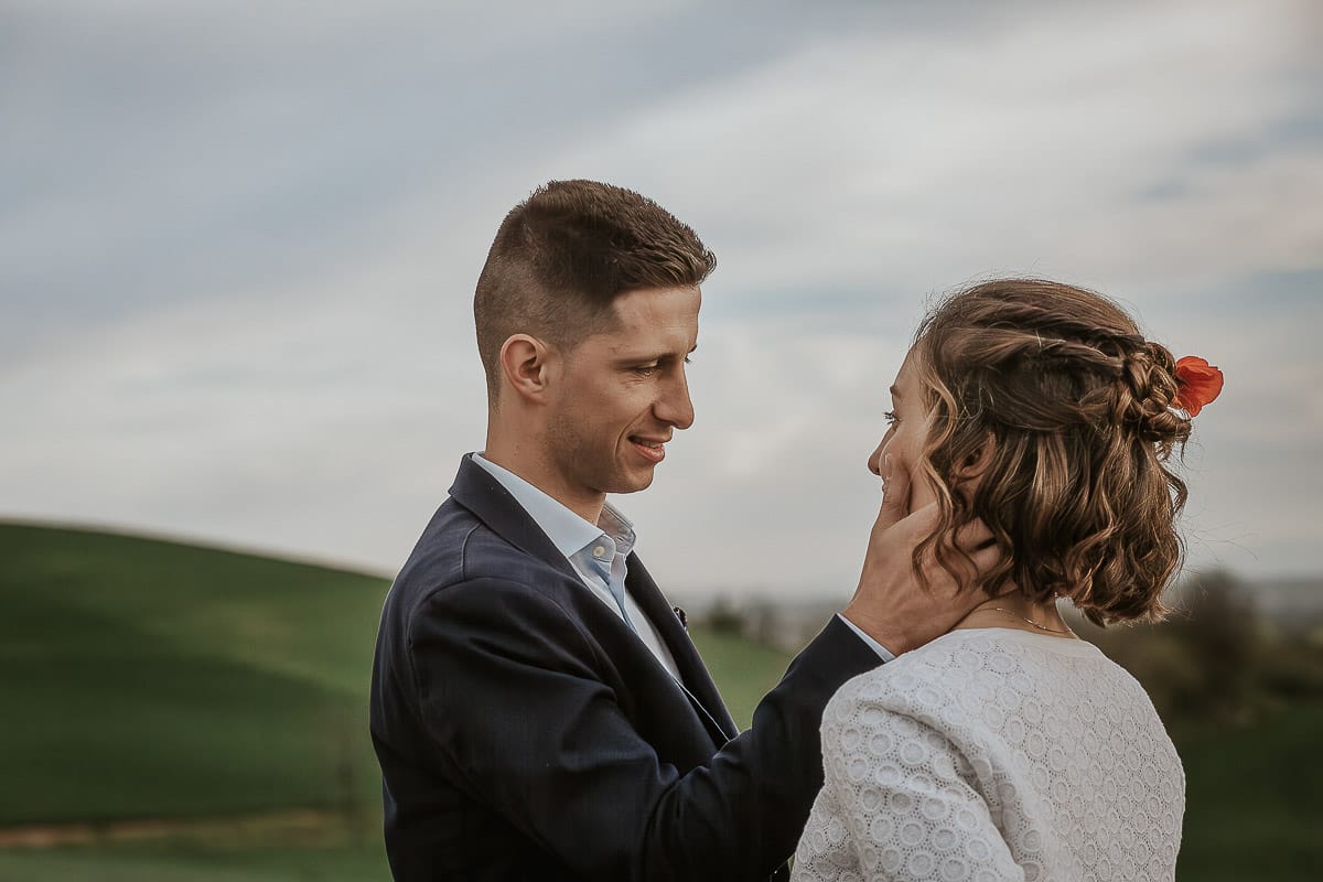 Prewedding primaverile in collina a Mombello di Torino di Federica e Mattia. Mattia accarezza Federica sulla guancia.