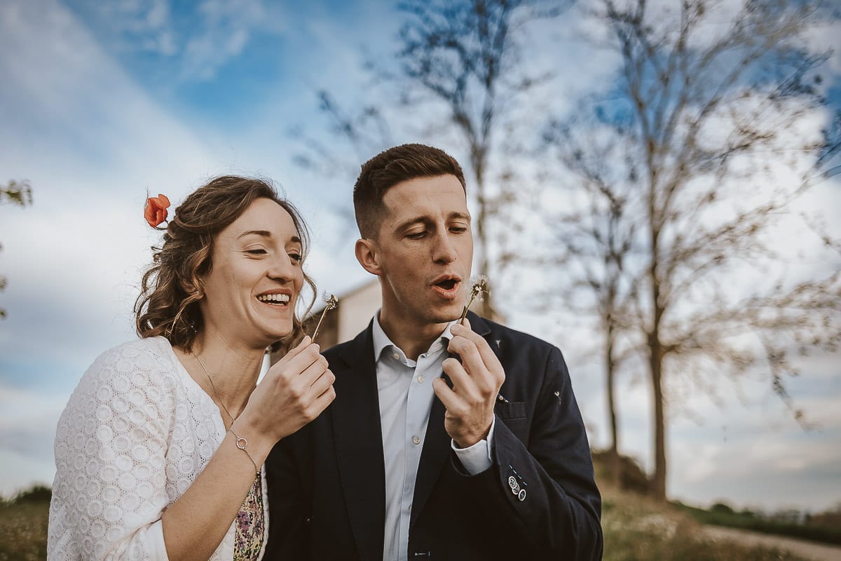 Prewedding primaverile in collina a Mombello di Torino di Federica e Mattia. Federica e mattia soffiano un soffione
