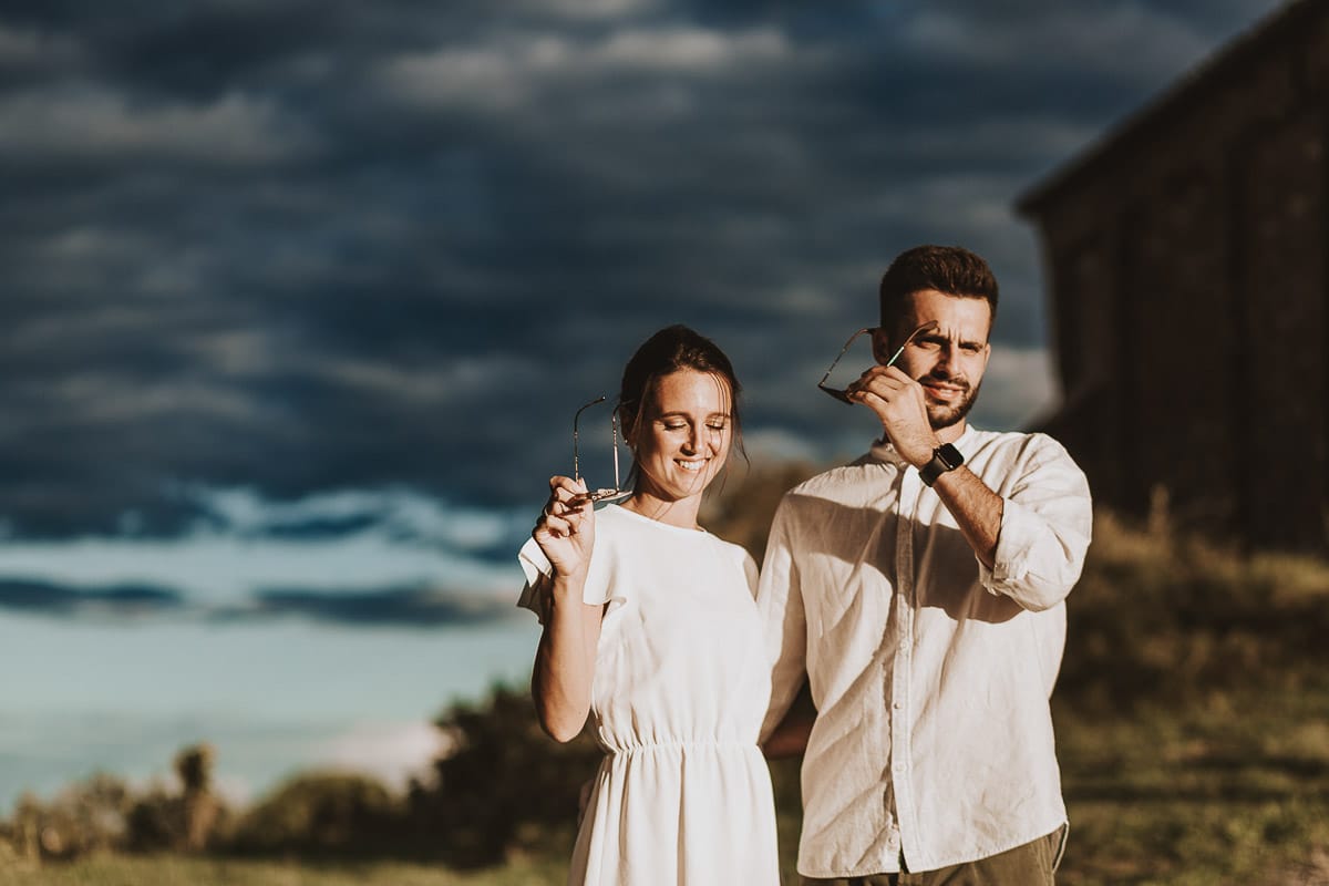 Prewedding spontaneo e poetico nel Monferrato a Mombello di Torino. Federica e Riccardo camminano abbracciati togliendosi gli occhiali da sole