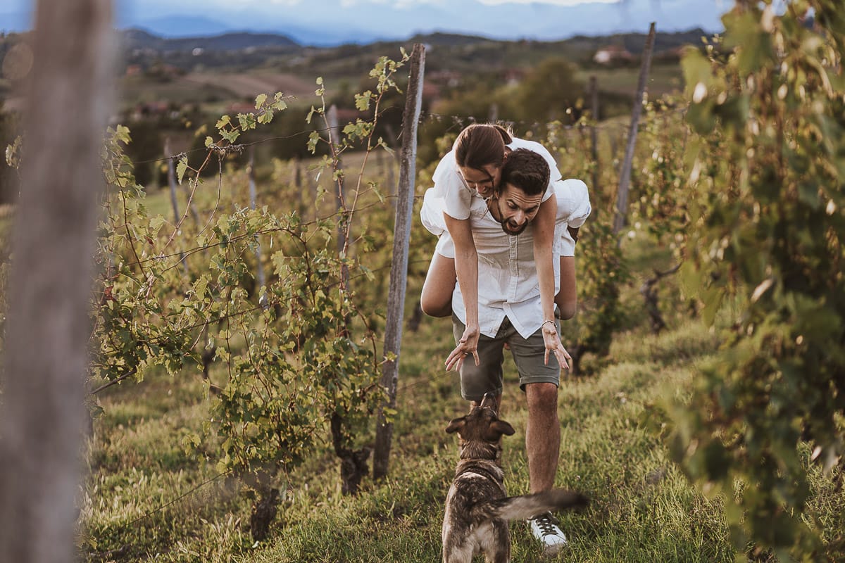 Prewedding spontaneo e poetico nel Monferrato a Mombello di Torino. Federica e Riccardo nel vigneto giocano. Federica salta sulla spalla di Riccardo.