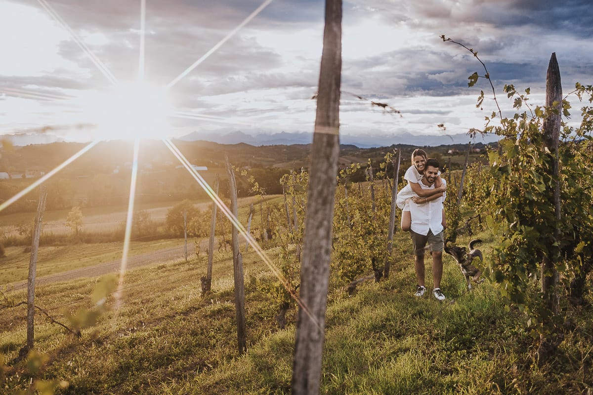 Prewedding spontaneo e poetico nel Monferrato a Mombello di Torino. Federica e Riccardo nel vigneto giocano. Federica salta sulla spalla di Riccardo.