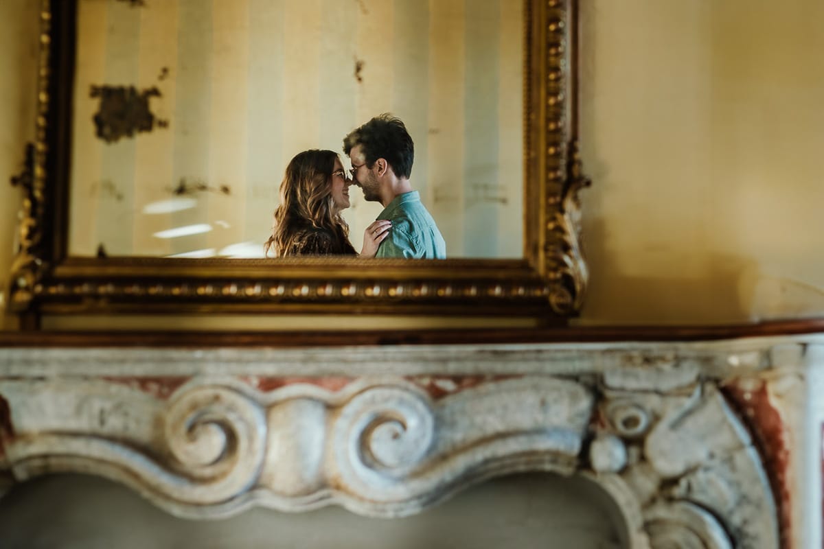 Fotografo matrimonio Rivalba. Villa Ala. Prewedding di Giorgia e Marco. la coppia riflessa nella specchiera del camino