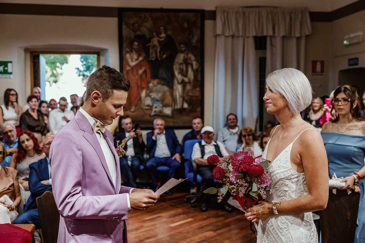 Matrimonio boho-chic da favola nel Monferrato. Fotografo matrimonio Monferrato. matrimonio a Molare (AL). cerimonia civile nel comune di Molare. Sposo legge le promesse.