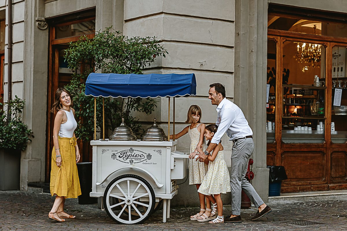 Fotografia di famiglia in vacanza a Torino: famiglia in piazza Carignano vicino al carrettino dei gelati vintage di Pepino.