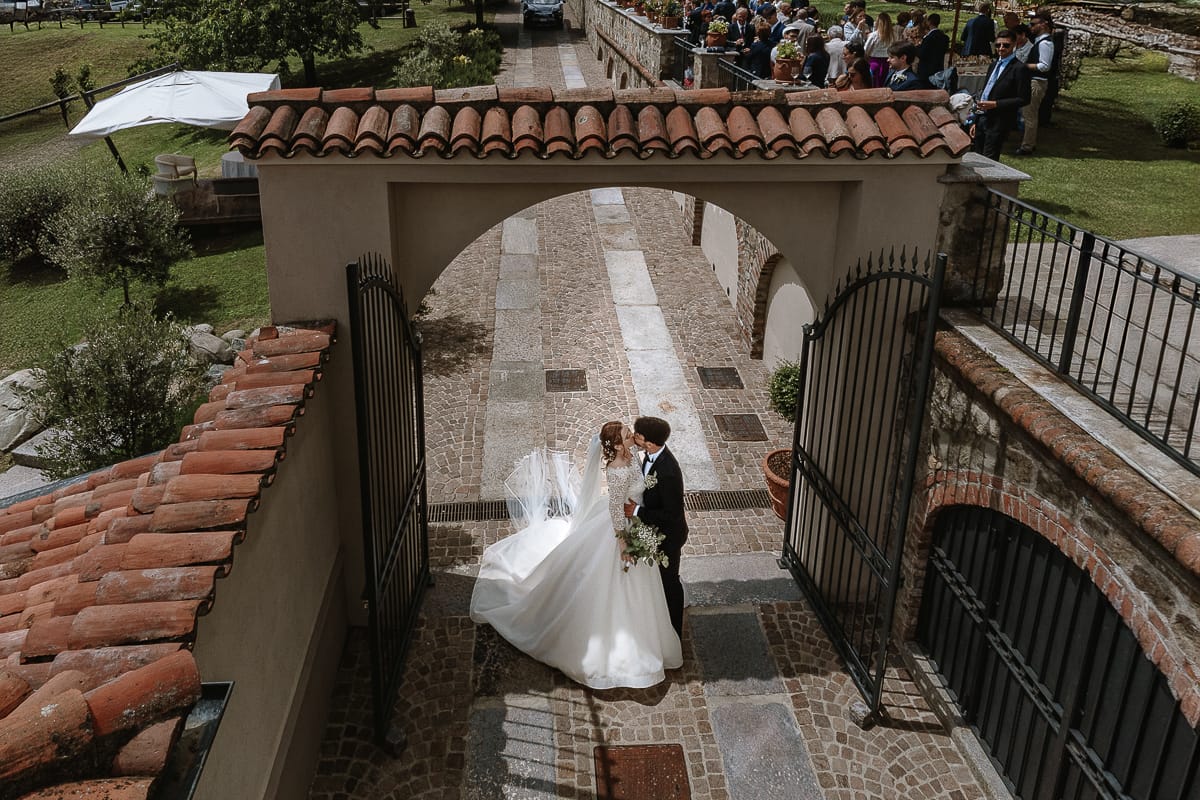 Matrimonio a Villa Ala di Rivalba (TO) Sposi si guardano sotto l'arco d'ingresso. foto dal drone.
