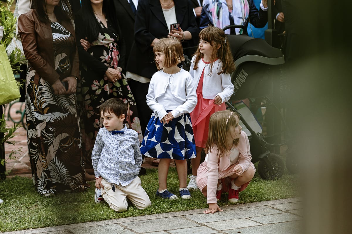 Fotografo matrimonio Torino. Momento aperitivo a Villa Ala. Invitati ascoltano il pianoforte e il canto. dettaglio sui bambini.