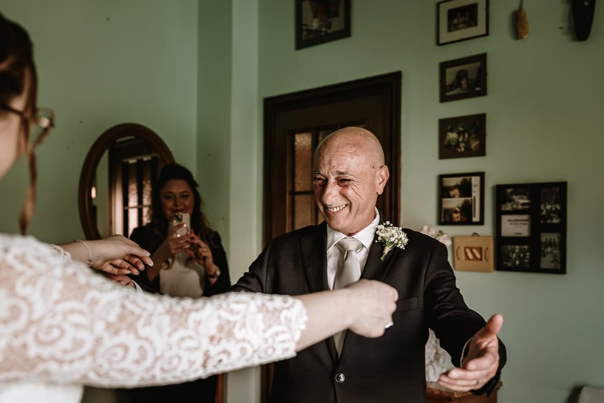 Preparazione della sposa a Madonna della Scala. Il papà commosso sta per abbracciare la sposa.