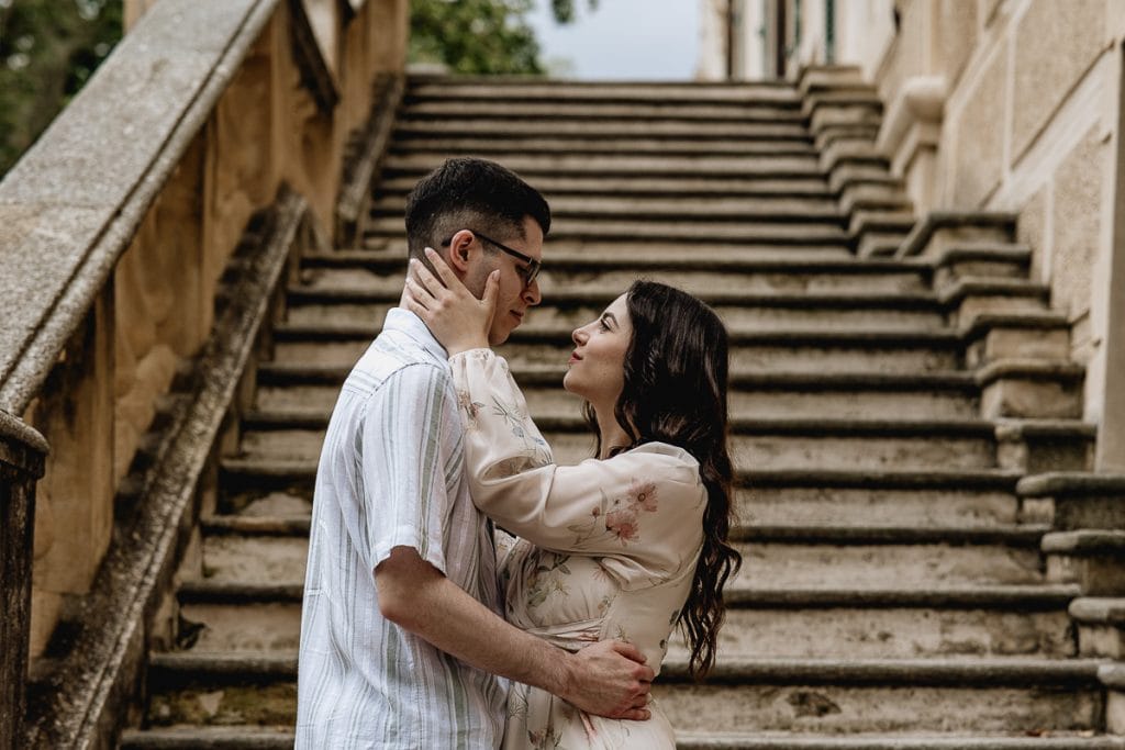 Pre-wedding at Castello di Santena. Fabiola and Cristian on the castle steps. Fabiola is holding Cristian's face in her hands.  