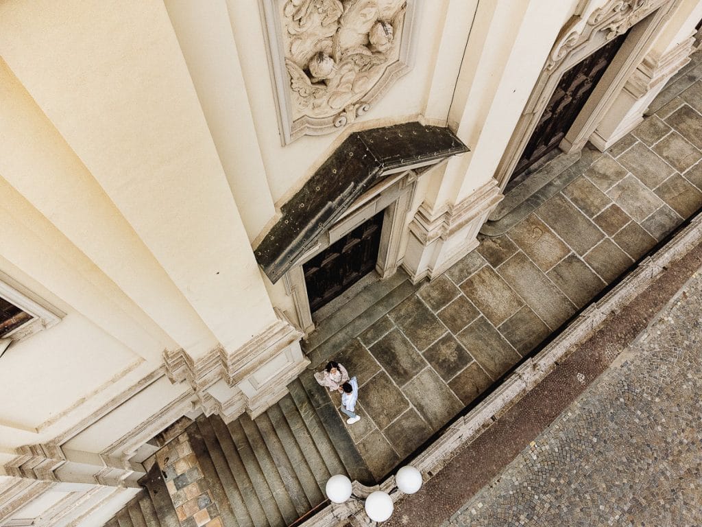 Pre-wedding at Castello di Santena. Fabiola and Cristian on the church steps.  Aerial Drone Photography.