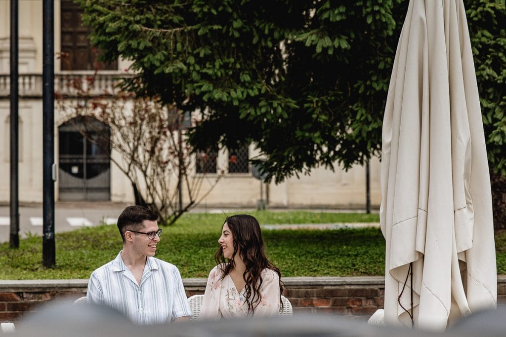 Pre-wedding at Castello di Santena. Fabiola and Cristian sitting in front of the church. 