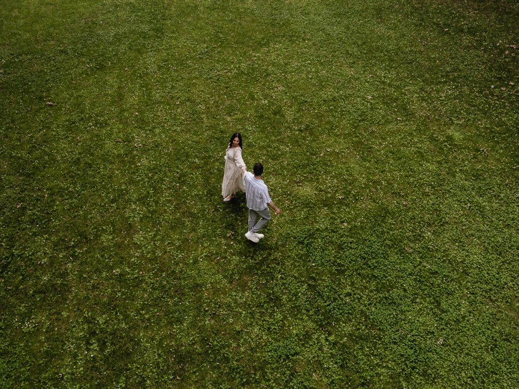 Pre-wedding at Castello di Santena. Fabiola and Cristian are holding hands. Aerial drone shot.  