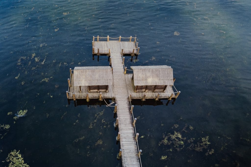 Aerial photography captures the magic of Ilaria and Luca's pre-wedding shoot at Lake Viverone, with a focus on the enchanting Pile Dwellings. 