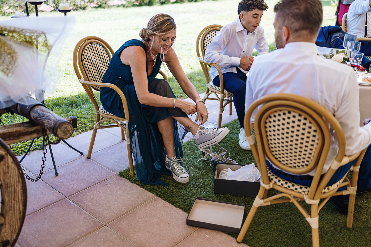 Fotografo Matrimonio in Piemonte. Ricevimento all'agriturismo Greppi di Crescentino (VC). Aperitivo. Testimone si cambia le scarpe.