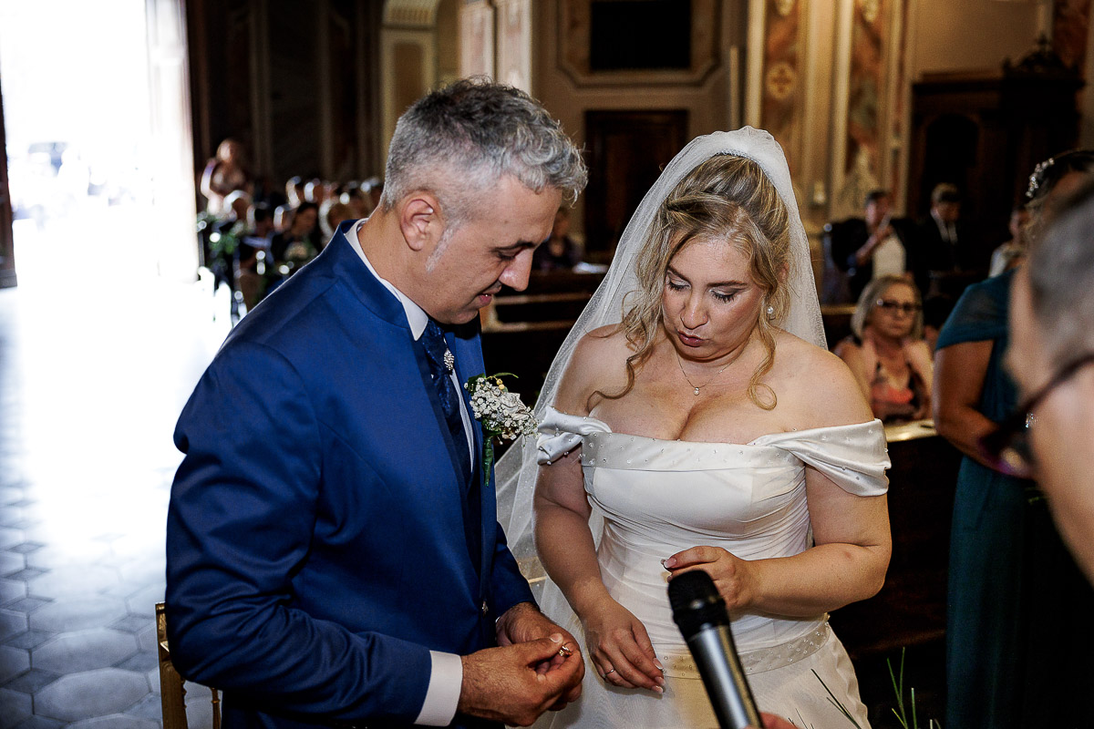 Fotografo Matrimonio in Piemonte. Cerimonia nella chiesa di San Giovanni Battista di Moriondo Torinese. sposo prende l'anello.