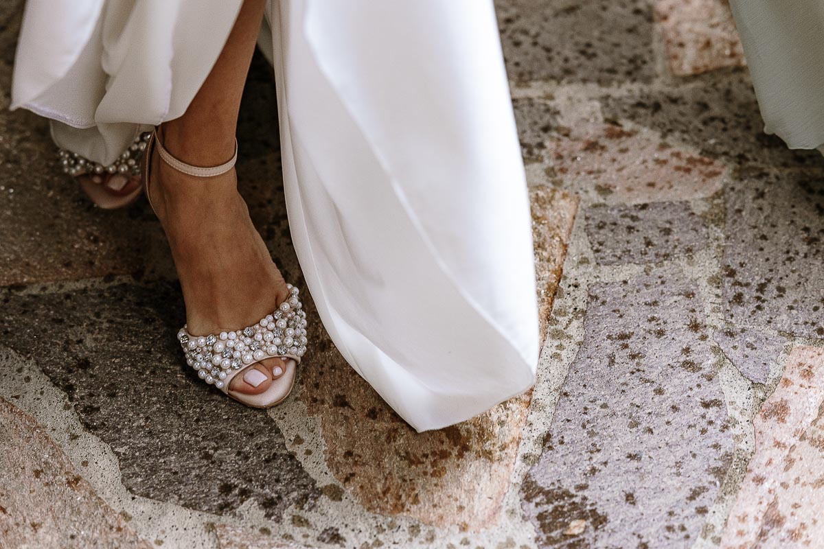 Fotografo Matrimonio Lago di Viverone, Tenuta Variselle. Cerimonia religiosa secondo il rito della Chiesa di Antiochia. dettaglio sulla scarpa della sposa