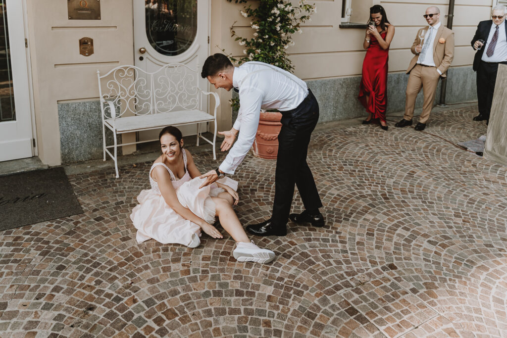 婚礼纪实摄影 – 新娘在舞蹈中跌倒后，有些害羞却满脸笑意地坐在地上 